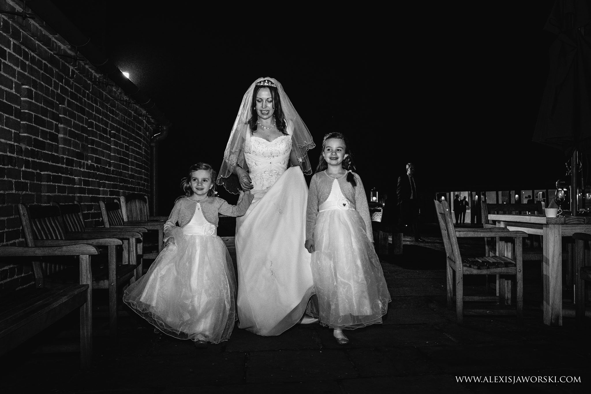 bride walking with flower girls