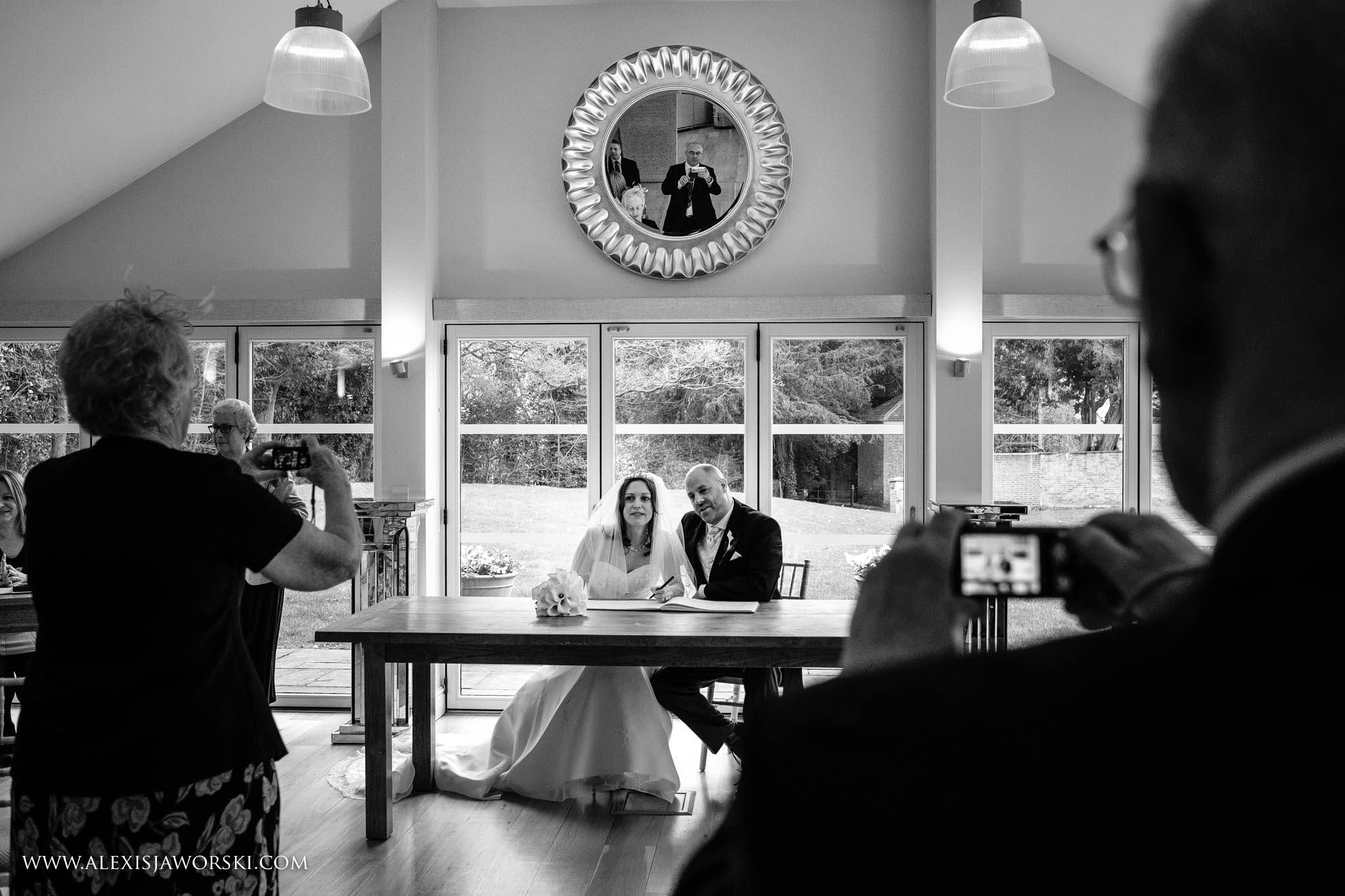 bride and groom signing the register