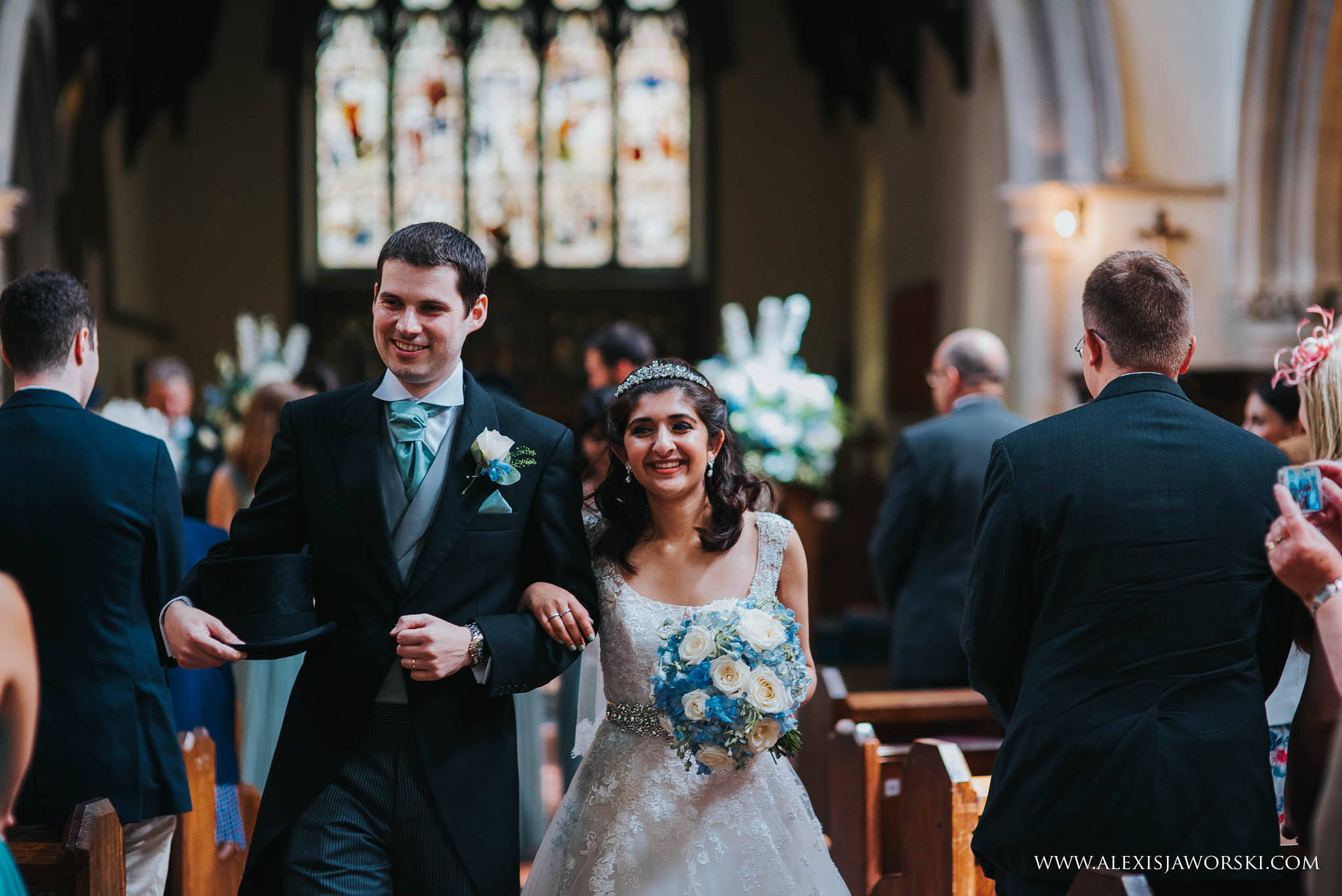 bride and groom smiling at guests