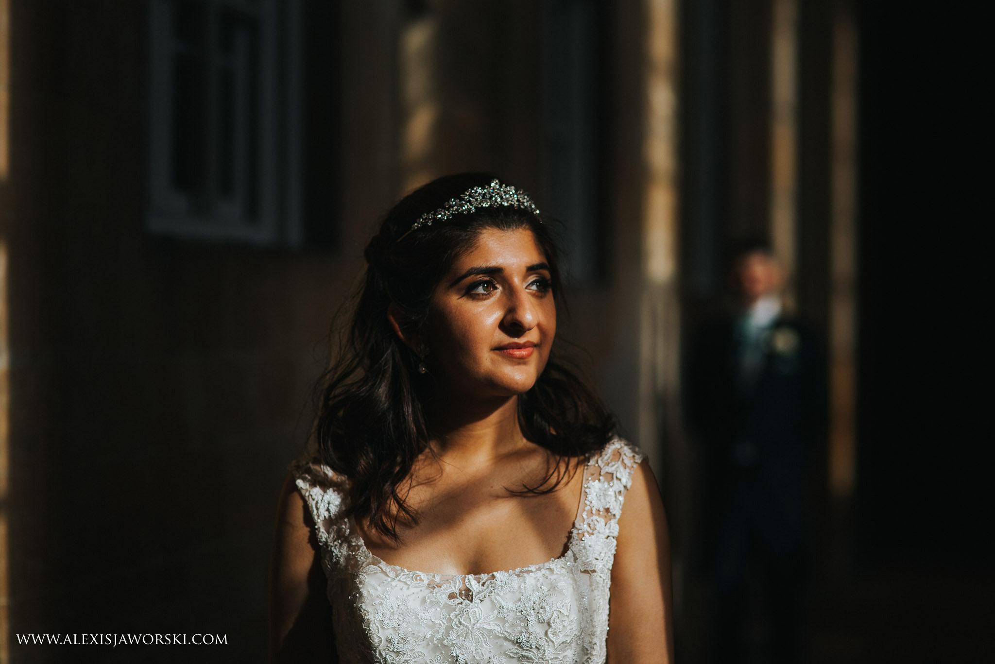 portrait of bride with groom in background