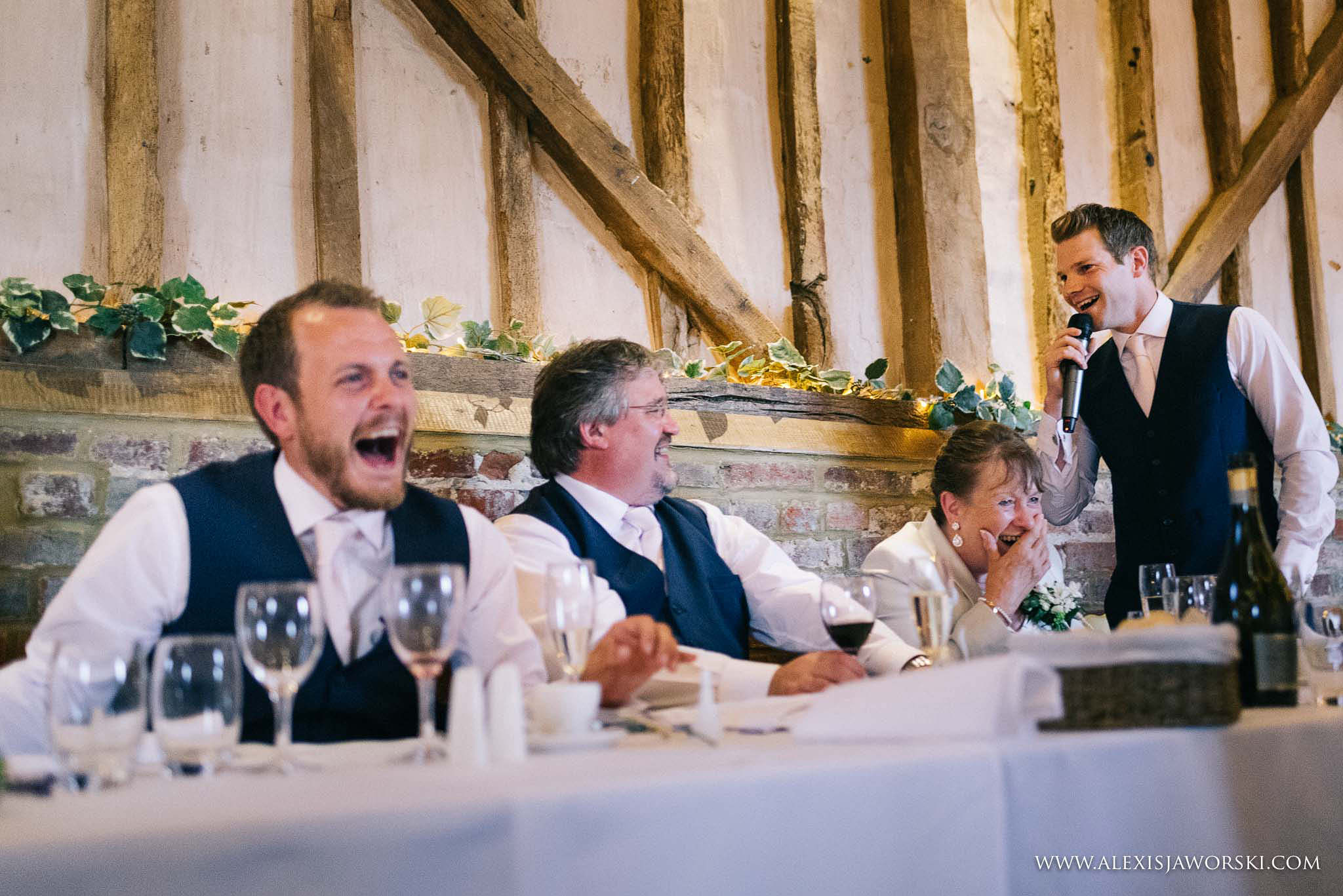 groom laughing to best man's speech