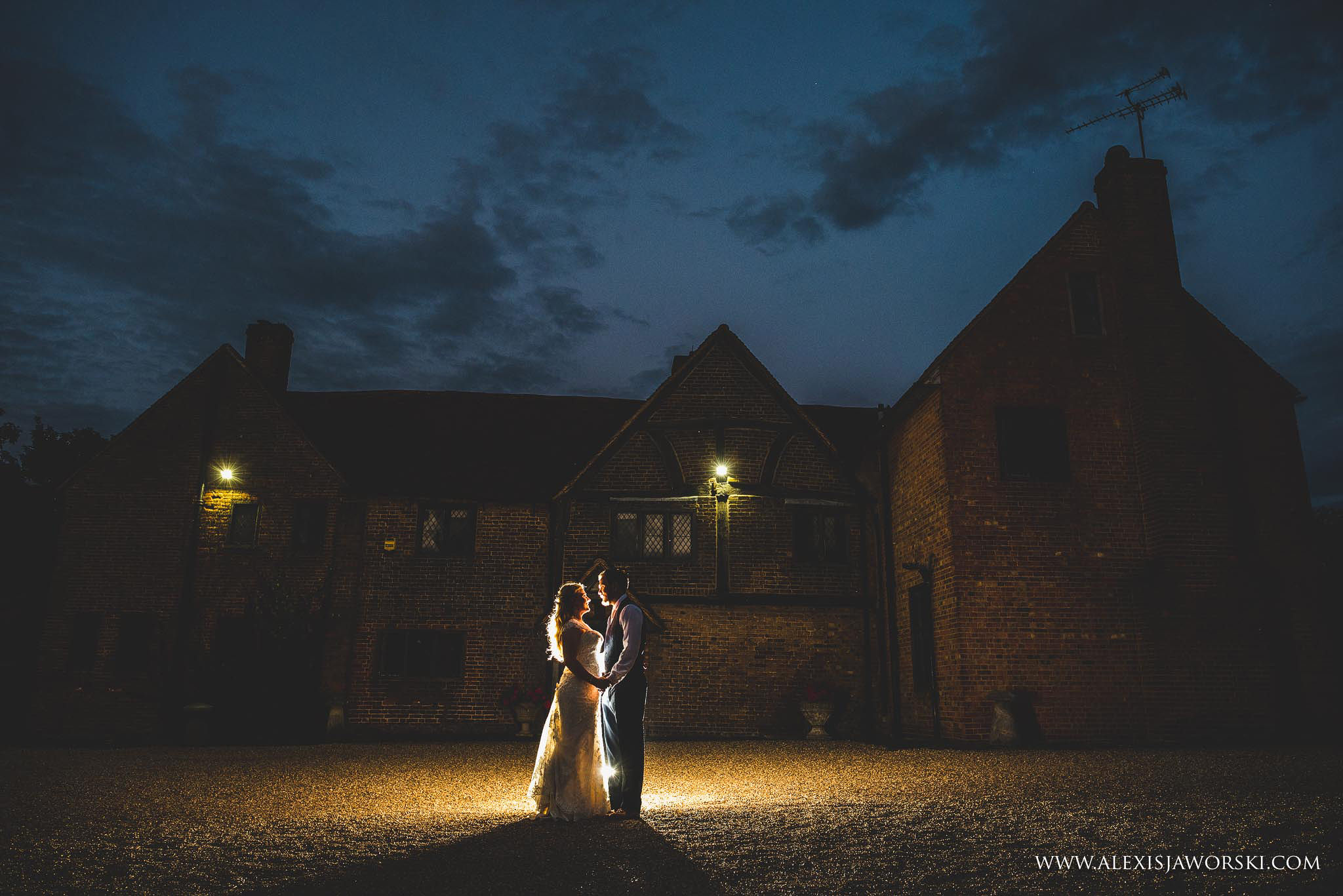 an outdoors portrait of the bride and groom at night