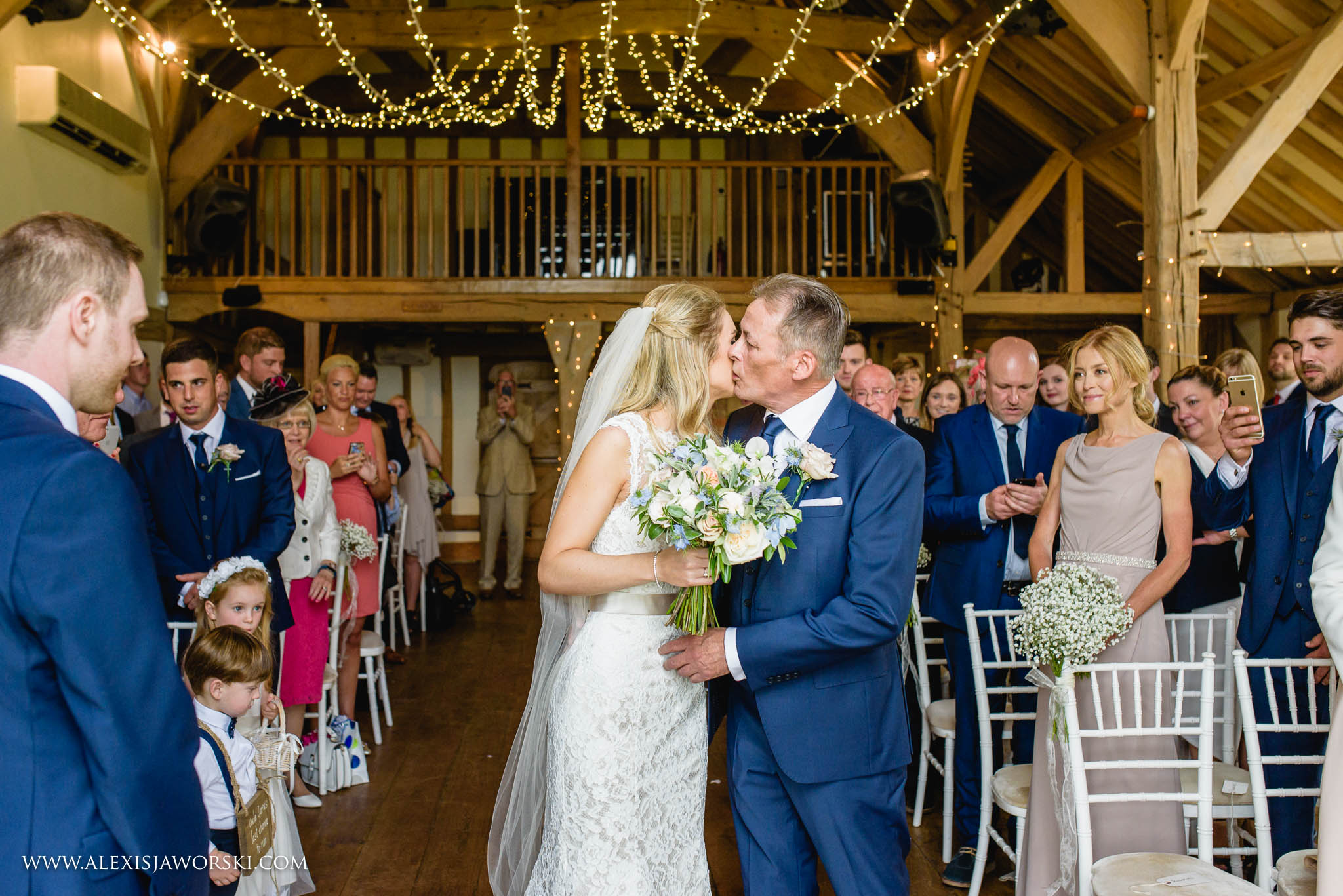 father of the bride kissing bride